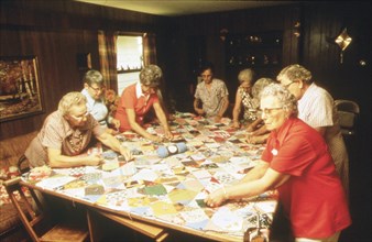 Senior citizens work hard on making a quilt in New Ulm