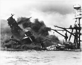 The battleship USS ARIZONA sinking after being hit by Japanese air attack on Dec. 7