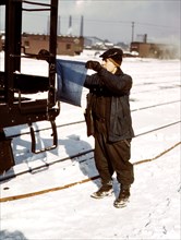 Train car inspector blue flagging a train for inspection at Corwith yard