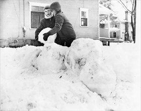 Two Boys Building Snowman in Yard November 1966