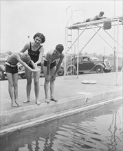 Woman and children at swimming pool