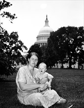 Woman and infant on lawn