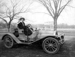 Woman driving a car ca. 1905