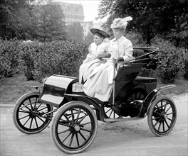 Woman driving an auto in very early 1900s