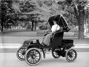 Woman driving an automobile in early 1900s