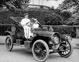Woman driving an automobile in early 1900s