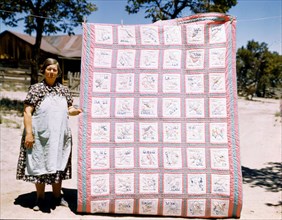 Woman quilter with state quilt which she made