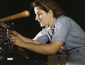 Woman working on transport parts in the hand mill