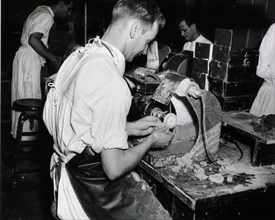 Worker Grinding dental plates ca. 1944