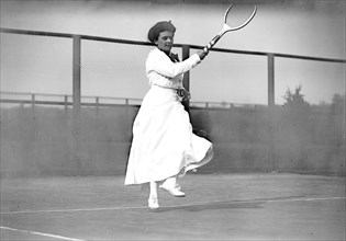 Miss E. Little playing tennis