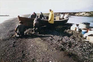September 1976 - Eskimo family portaging boat and camp gear at Anygaak, at the mouth of Tukruk Channel, an important location for the harvesting of whitefish during early fall