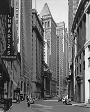 1930s New York City - Buildings lining Broad Street, including Schwartz's restaurant, left foreground, and a building with scaffolding (looking towards Wall Street (ca. 1936)