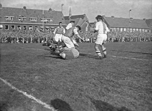 1940s Men's Soccer Match - Volewijckers - Ajax 1-0. Ajax keeper Keizer throws himself for upcoming Volewijckers attack (October 10, 1947; Amsterdam)
