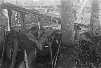Three shooters in an excavated position; Date May 1946; Location Indonesia, Dutch East Indies