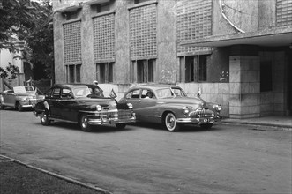 Cars parked in front of GS Headquarters in Batavia, Indonesia, Java, Dutch East Indies ca. 1948