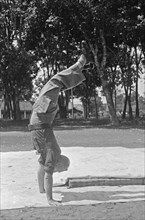 Dutch serviceman does handstand; Date June 1947; Location Indonesia, Dutch East Indies