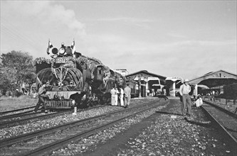 Decorated steam locomotive at station in Bandung, Indonesia, Dutch East Indies ca. April 1948