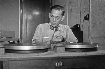 1947 - Gramophone records are on turntables. Behind it a technician - Indonesia, Dutch East Indies