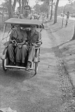 Two armed Dutch soldiers in a Bedjak in Batavia (Jakarta) Indonesia ca. 1947