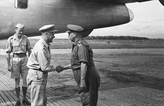 General Kruls shakes the hand of Colonel P. Scholten at an airport in Indonesia, Dutch East Indies ca. 1947