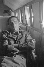 Sleeping officer on the plane; Date February 1947; Location Hollandia, Indonesia, Dutch East Indies, New Guinea
