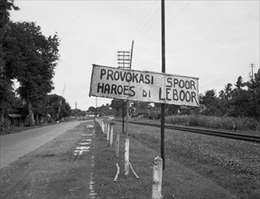 Indonesia History - A long road with a railway line. On a plate the text 'Provokasi Spoor haroes di leboor' ca. 1947 (Indonesia)