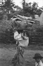 Refugees returning to Republican territory. Woman with child in slendang and luggage on her head in Java, Dutch East Indies, Salatiga ca. December 1947