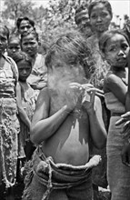 A young girl smokes a cigarette in Indonesia, Java, Dutch East Indies, Salatiga ca. 1947