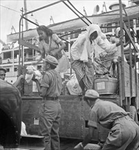 Female passengers leave a truck; Date January 22, 1948; Location Indonesia, Dutch East Indies, Padang, Sumatra