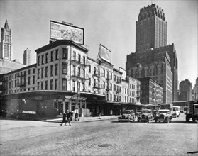 Billboards top buildings at the corner of Warren and West Sts., cars stopped in street, Telephone and World Telegram building beyond at r. West Street Row: V, between Warren & Murray Streets, Manhatta...