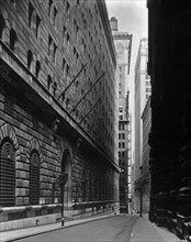 1930s New York City - Massive facade of Federal Reserve building fills left side, looking down Maiden Lane ca. 1936