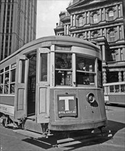 1930s New York City - Third Ave. trolley in front of old Post Office, and Woolworth building, left, driver and riders visible through windows ca. 1938