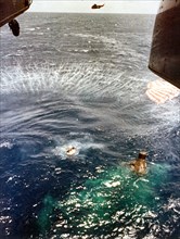 (16 May 1963) A U.S. Navy frogman, deployed from the hovering helicopter, swims next to the spacecraft and makes contact with astronaut L. Gordon Cooper Jr. inside, as his fellow team members bring up...