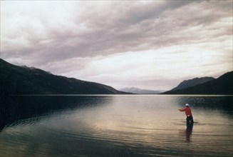 Man fishing in Walker Lake, Alaska July 1974