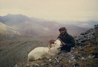 July 1974 - Hunter holding head of Dall sheep ram shot near July Creek, Alaska