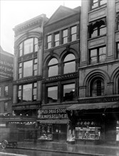 Exterior of People's Drug Store, 11th and G Streets, Washington, D.C., with other shops ca. 1909-1932