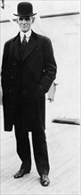 Henry Ford, full-length portrait, standing, facing left 1916