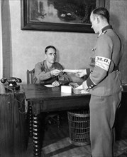 Sergeant Francis J. Walsh Gives Instructions to a German Master Sergeant in Uniform ca. 6/1945