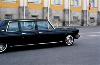 Luxury automobile driving down street in Russian city ca. 1970s (1978)