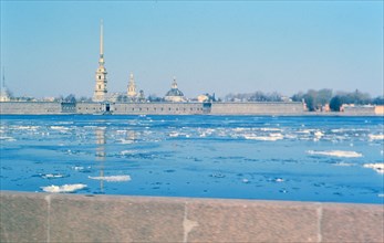 Partially frozen river in foreground , buildings of a major city in Russia in the background - late 1970s (1978)