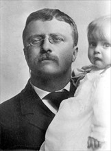 Theodore Roosevelt, holding child