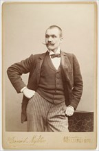 Photography studio portrait of Axel Gallén, leaning