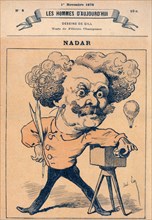 French caricature of photographer and balloonist Nadar, standing next to his camera and holding a quill pen ca 1878