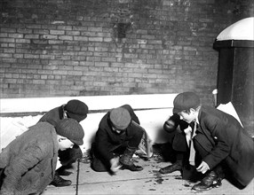 A group of Newsies playing craps in the jail alley at 10 P.M. Albany, N.Y., February 1910