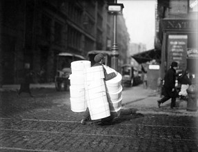 Boy carrying hats. New York City, February 1912