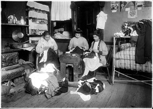 Family finishing pants. None of them spoke English. New York City, March 1912