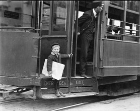 Five year old Newsie jumps on and off streetcars to sell newspapers 1910
