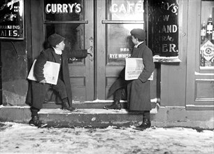Newsies in early 1900s entering a bar to sell papers to customers