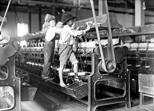 Dangerous work for young children in a textile factory.