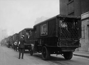 Photograph shows American Express trucks transporting gold shipped by Great Britain to New York City for safe-keeping during World War I ca. September 8, 1915